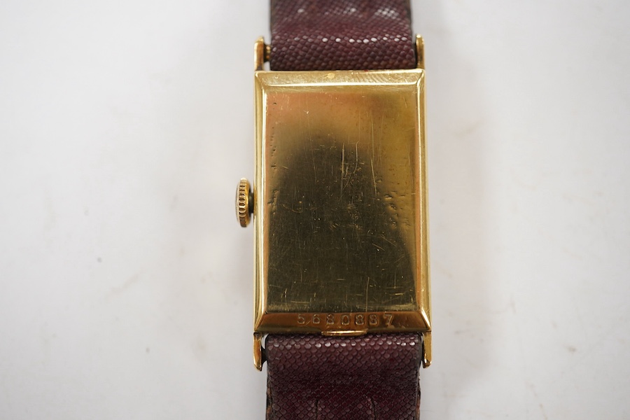 A gentleman's 14k gold Longines manual wind wrist watch, with rectangular dial, baton numerals and subsidiary seconds, case diameter 20mm, on a later associated strap. Condition - fair